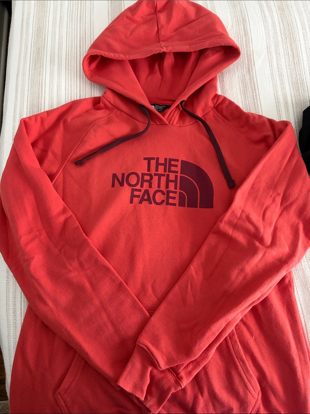 The Northface women’s hoodie sz M in coral and maroon